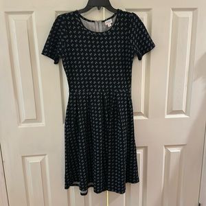 Black floral LuLaRoe dress with pockets and back zipper. Size medium.